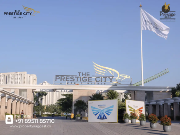 Entrance view of Eaton Park at The Prestige City residential towers in Yamare Village, Sarjapur Road, Bangalore, featuring high-rise apartments surrounded by greenery and a waterfront, developed by Prestige Group.