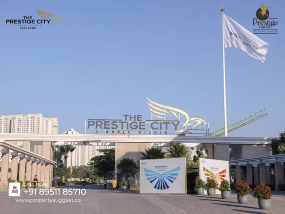 Entrance view of Fernvale at The Prestige City residential towers in Yamare Village, Sarjapur Road, Bangalore, featuring high-rise apartments surrounded by greenery and a waterfront, developed by Prestige Group.